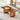 Walnut wood coffee table with rattan panel legs in cozy living room setting