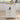 White kitchen island with wooden top in a modern kitchen setting