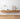 Wooden floating shelf with decorative items against a white wall