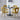 Four yellow velvet bubble back dining chairs paired with black round table