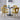 Four yellow velvet bubble back dining chairs paired with black round table