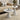 Modern Round-Top Pedestal Side Table placed in a living room with neutral tone