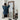 lady standing before a mirror in denim shirt