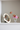 Glass flower vase and framed mirror set on counter